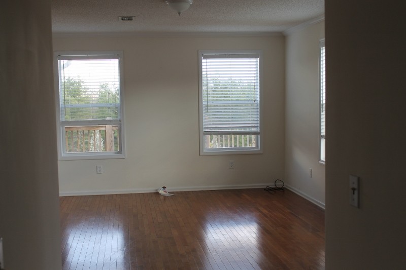 hardwood floors and large window in living room
