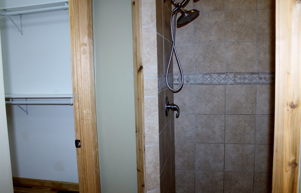 tiled shower and large walk-in closet